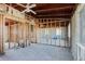 Shell of an unfinished living room, showing exposed ceiling and wood framing in an open-concept space at 596 S Bayshore Dr, Madeira Beach, FL 33708