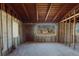 Partially constructed living room with exposed frame, block walls, ceiling, and an exterior door at 596 S Bayshore Dr, Madeira Beach, FL 33708