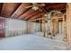 The framed shell of an unfinished living room featuring exposed ceilings, natural light, and window views at 596 S Bayshore Dr, Madeira Beach, FL 33708