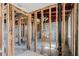 Living room under construction showcasing exposed beams and pipes for renovation at 596 S Bayshore Dr, Madeira Beach, FL 33708