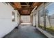 Enclosed sunroom featuring weathered walls and a concrete floor; in need of some TLC and upgrades at 596 S Bayshore Dr, Madeira Beach, FL 33708