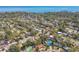 A beautiful aerial of a tree-filled neighborhood showcasing the waterfront in the distance at 5998 Grove S St, St Petersburg, FL 33705