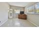 This bedroom features a terrazzo floor, soft gray walls, and dresser with a television set at 5998 Grove S St, St Petersburg, FL 33705