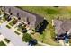 An aerial view showcases the townhouse with lush landscaping, multiple parking spaces, and a well-maintained exterior at 6907 Holly Heath Dr, Riverview, FL 33578
