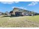 A spacious backyard featuring a screened-in porch and lush green grass, perfect for outdoor enjoyment at 6907 Holly Heath Dr, Riverview, FL 33578