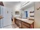 This bathroom features a double sink vanity, modern fixtures, and a large mirror at 6907 Holly Heath Dr, Riverview, FL 33578