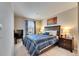 This bedroom features soft carpet, a large window, and classic decor at 6907 Holly Heath Dr, Riverview, FL 33578