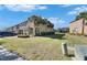 Townhouse showcasing manicured lawn, side yard and curb appeal with mature landscaping, enhancing community charm at 6907 Holly Heath Dr, Riverview, FL 33578