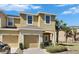 Inviting exterior of a two-story townhome featuring a private garage, lush landscaping and a sunny sky at 6907 Holly Heath Dr, Riverview, FL 33578