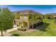 Two-story home featuring a well-maintained lawn, and palm trees, enhancing curb appeal and natural charm at 6907 Holly Heath Dr, Riverview, FL 33578