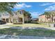 Charming two-story townhouse with an attached garage, palm trees and a well-manicured lawn at 6907 Holly Heath Dr, Riverview, FL 33578