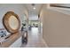 Inviting hallway with tile flooring, a decorative mirror, and seamless flow to the living spaces at 6907 Holly Heath Dr, Riverview, FL 33578