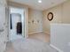 Second-floor hallway leads to bedroom with natural light and neutral carpeting at 6907 Holly Heath Dr, Riverview, FL 33578