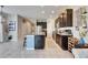 Well-lit kitchen with dark cabinetry, stainless steel appliances, and large island with granite countertops at 6907 Holly Heath Dr, Riverview, FL 33578