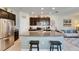 Kitchen with stainless steel appliances, dark cabinets, granite countertops, and large kitchen island at 6907 Holly Heath Dr, Riverview, FL 33578