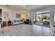 Cozy living space with tile floors and sliding glass doors to the screened lanai at 6907 Holly Heath Dr, Riverview, FL 33578