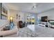 Bright living area with neutral walls, tile floors, and access to a screened lanai and backyard at 6907 Holly Heath Dr, Riverview, FL 33578
