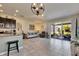Open-concept living room with tile floors and access to a screened patio with outdoor seating at 6907 Holly Heath Dr, Riverview, FL 33578