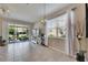Spacious living area with tile floors, large windows and adjacent screened lanai and backyard at 6907 Holly Heath Dr, Riverview, FL 33578