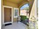 Welcoming front porch with an arched entrance, chair, potted plants, and a view of the outdoors at 6907 Holly Heath Dr, Riverview, FL 33578