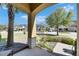 Relaxing porch with pillars offers a serene view of the neighborhood and lush landscaping at 6907 Holly Heath Dr, Riverview, FL 33578