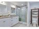 Modern bathroom with double vanity, granite countertops, and a glass-enclosed tiled shower at 7040 Dr Martin Luther King Jr S St, St Petersburg, FL 33705