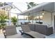 Covered and screened patio area with lounge chairs, comfortable seating, and access to the sparkling swimming pool at 7040 Dr Martin Luther King Jr S St, St Petersburg, FL 33705