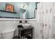 Stylish bathroom featuring a vessel sink, floral shower curtain, and contrasting black and white tile at 777 29Th N Ave, St Petersburg, FL 33704