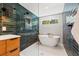 Spa-like bathroom featuring a freestanding tub, decorative tile, and a modern shower with sleek fixtures at 777 29Th N Ave, St Petersburg, FL 33704