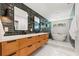 A modern bathroom boasts a double sink vanity, sleek dark fixtures, and a luxurious soaking tub at 777 29Th N Ave, St Petersburg, FL 33704