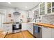 Well-lit kitchen with stainless steel appliances, stylish backsplash, and ample counter space at 777 29Th N Ave, St Petersburg, FL 33704