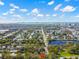 Beautiful aerial view showcases the property's location with trees, lake, and city skyline on a sunny day at 803 S Evergreen Ave, Clearwater, FL 33756