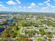 Scenic aerial view of the property surrounded by lush green landscape, blue lake, and neighborhood at 803 S Evergreen Ave, Clearwater, FL 33756
