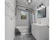 Charming bathroom featuring a clawfoot tub, black and white patterned tile floor, and modern vanity at 803 S Evergreen Ave, Clearwater, FL 33756