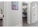 Hallway leading to bedroom with bunk beds, featuring neutral walls and tile flooring at 803 S Evergreen Ave, Clearwater, FL 33756