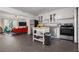 Open concept kitchen flows into living area, stainless appliances, and white cabinetry at 803 S Evergreen Ave, Clearwater, FL 33756