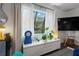 Living room featuring a picture window with curtains and a view of the home across the street at 803 S Evergreen Ave, Clearwater, FL 33756