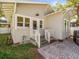 Charming back porch with a white railing and brick pavers, perfect for outdoor relaxation at 803 S Packwood Ave, Tampa, FL 33606