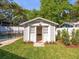 Charming backyard shed with french doors and meticulous landscaping next to a refreshing pool at 803 S Packwood Ave, Tampa, FL 33606