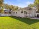Spacious backyard with well-maintained lawn, a patio, and a charming rear elevation at 803 S Packwood Ave, Tampa, FL 33606