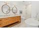 Bright bathroom features a double vanity, soaking tub and glass enclosed shower with tile surround at 803 S Packwood Ave, Tampa, FL 33606
