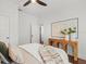 Bright bedroom features hardwood floors, comfortable bed with accent pillows, and console table at 803 S Packwood Ave, Tampa, FL 33606