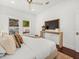 Bright bedroom features a window, hardwood floors, console table, and decorative pillows at 803 S Packwood Ave, Tampa, FL 33606