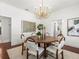 Bright dining room featuring a modern chandelier, hardwood floors, and elegant decor at 803 S Packwood Ave, Tampa, FL 33606