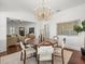 Elegant dining room showcasing a modern chandelier, hardwood floors, and stylish decor at 803 S Packwood Ave, Tampa, FL 33606