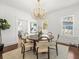 Inviting dining room with hardwood floors and a modern chandelier, flowing into the living area at 803 S Packwood Ave, Tampa, FL 33606