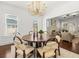 Open dining area with modern lighting and hardwood floors, seamlessly connected to the living room at 803 S Packwood Ave, Tampa, FL 33606