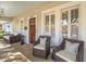 Relaxing front porch with comfy seating and charming details, perfect for enjoying the outdoors at 803 S Packwood Ave, Tampa, FL 33606