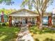 Charming craftsman home featuring a welcoming front porch, red brick accents, and a well-manicured lawn at 803 S Packwood Ave, Tampa, FL 33606