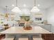 Bright kitchen with an island, custom cabinetry, stainless steel appliances, and a cozy breakfast nook at 803 S Packwood Ave, Tampa, FL 33606